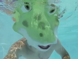 Swimmer in a Frog Costume Swim Underwater Stock Footage