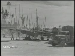 1943: BOUGAINVILLE CAMPAIGN: VS Allied military air base in Solomon Islands, damaged or incomplete aircraft on field, tents. WWII, World War II, Pacific Front, Operation Cartwheel Instructional Video
