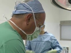 Doctors in operating room performing surgery Stock Footage