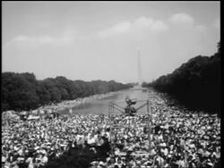 B/W August 28, 1963 wide shot huge crowd cheering at March on Washington /  Washington Monument in background Stock Footage