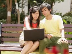 Teenage couple chatting on a laptop  Stock Footage