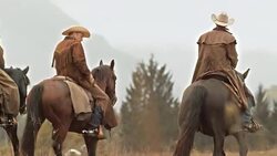 DS TU Three ranchers talking while riding horses across meadow Stock Footage
