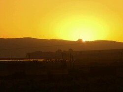 Yellow sun setting behind mountain, shot from Santa Rosa, Bolivia Stock Footage