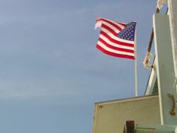 MS Shot of United States flag waving on beach / Los Angeles, California, United States Stock Footage