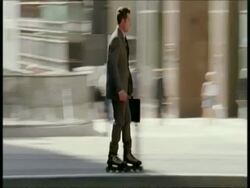 MS business man on rollerblades weaves in and out of traffic and pedestrians Stock Footage