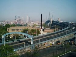 Time lapse, early morning vista with Philadelphia cityscape and traffic crossing The Ben Franklin Bridge. Stock Footage