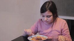 little girl eating spaghetti Stock Footage