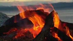 A campfire burns near a sea. Stock Footage