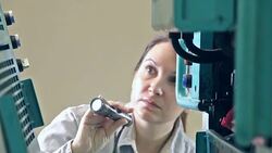 Female repairman examining equipment with flashlight Stock Footage