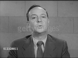 1952: JOHN DAVY NEWS OF THE MOMENT: VS Male (middle age, 40's, 50's) entering living room, turning on television set. VS News reporter John Davy speaking (SOT) about Korean War, U.S. Presidential campaign (between Dwight Eisenhower & Adlai Stevenson) Instructional Video