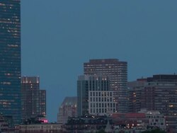 Amazing shot of super full moon rising over Boston Downtown after dark. TL day to night Stock Footage
