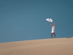 Woman with scarf in desert Stock Footage