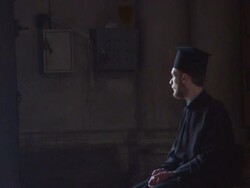 MS TD Orthodox priest sitting in stone chapel / Jerusalem, Israel Stock Footage