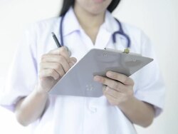 Female Doctor Writing Report on Clipboard Stock Footage