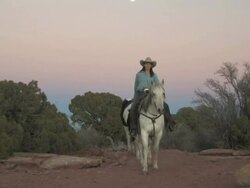 MS ZO Women Riding Horses through Majestic Red Rock Mountains with full moon / Telluride, Colorado, United States  Stock Footage