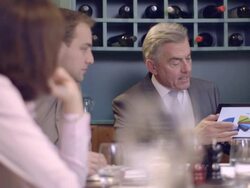 MS PAN Business people using tablet and talking in restaurant Stock Footage