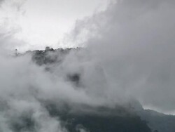 Wispy clouds obscuring forested clifftop, rural Cundinamarca region, Colombia Stock Footage