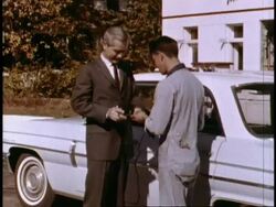 Traveling salesman stops at gas station and is eager to get back on the road Stock Footage