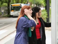 MS PAN Two women checking bus schedule and running after passing bus / Portland, Oregon, USA Stock Footage