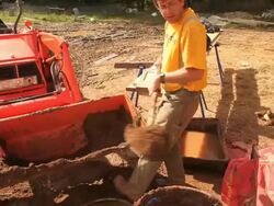 MS Carpenter adding clay into adobe mud mixture during  framing of an energy efficient post / Grass Lake, Michigan, USA    Stock Footage