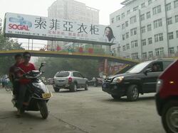 Traffic and pedestrians in smog in WuXue News Clip
