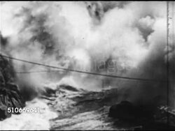 1952: CANADIAN BOOM: HA WS Simultanious explosions on both river bank & center explosion out of swirling smoke, WS Timber logging logs rolling down hill into water, TD VS logs moving in rapid moving river water. Natural resources, post-war economy. Instructional Video