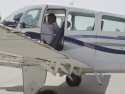 pilot applying wing flaps during pre flight inspection of aircraft, external view, RED R3D 4K Stock Footage