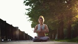 Young Woman Doing Yoga Meditation Exercises at Sunset Stock Footage