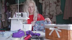 Woman in workshop sewing clothing Stock Footage