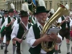  MS Bavarian brass band marching, following by others at opening of Oktoberfest / Munich, Bavaria, Germany Stock Footage