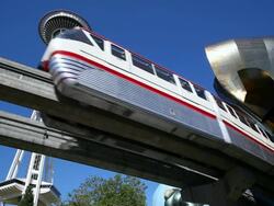 MS Shot of LA Monorail with Space Needle and Experience Music Project / Seattle, Washington, United States Stock Footage