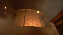 Smoke billows across a temple facade where monks wave flaming torches. Stock Footage