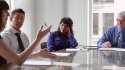 MS Businesswoman leading team meeting in office conference room with coworkers Stock Footage