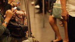 Crowded people in the mass public transportation using their phone while waiting Stock Footage