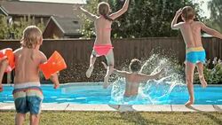 SLO MO DS Kids jumping into the pool Stock Footage