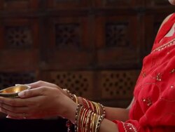 MS TU Young woman holding lit oil lamp in  hands / Singapore Stock Footage