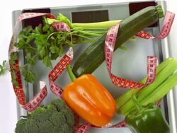 HD: Garden Vegetables On A Bathroom Scale Stock Footage