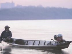 WS fisherman in boat on Mekong River / Vientiane, Laos Stock Footage