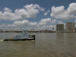 MS POV View of tugboat flowing on mississippi river in front of building / New Orleans, Louisiana, United States Stock Footage