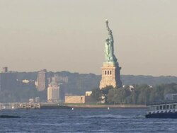 Water Taxi passes by the Statue of Liberty Stock Footage