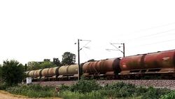 Freight train with petroleum tank cars passing Stock Footage