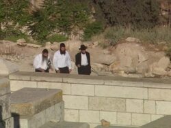 MS POV Three men walking up on gravel path toward  cemetery  / Jerualem, Israel Stock Footage
