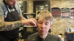 Male Hair stylist cutting male clients hair Stock Footage