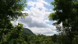 Timelapse of clouds rolling across the side of a mountain, 4K Stock Footage