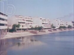Living at Thamesmead, 1973, part 2 - Young couple walking by the water Stock Footage