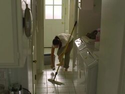 WS, PAN, Woman mopping tile floor in laundry room, Hollywood, California, USA Stock Footage