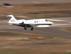 Aerial CU TS air to air with Lear Jet / Los Angeles International Airport, California, United States Stock Footage