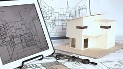 Architect working with house model & blueprints Stock Footage