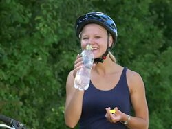 MS Shot of girl having rest with smiling and drinking water and cycle / Ockfen, Rhineland Palatinate, Germany Stock Footage