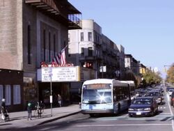 A traffic scene, with  an exterior of the Pavilion movie Theater in Prospect Park, Brooklyn showing the bike lane. Stock Footage